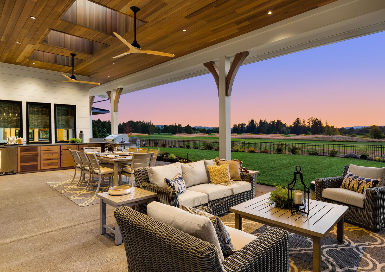 Covered outdoor kitchen with a generous concrete terrace and gathering space